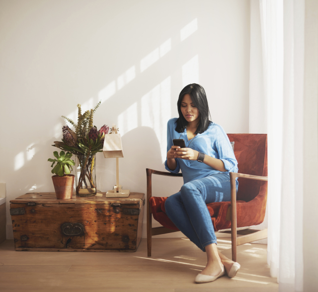 Woman sitting on a chair using her cellphone