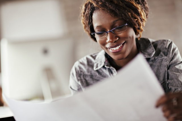 Photo of a woman reading a document